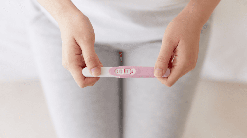 Un test de grossesse entre les mains d'une femme. C'est le bilan d'une femme de 37 ans qui n'a pas d'enfants.